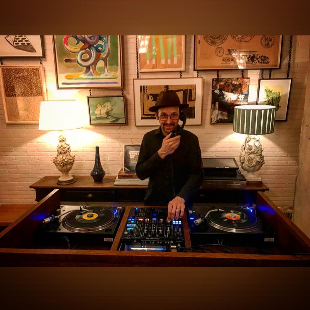 A set on two vinyl decks in a room with paintings on the wall