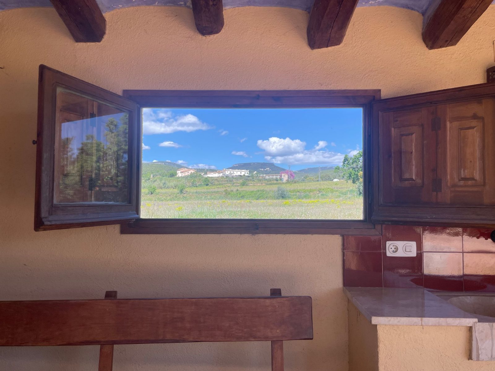 The porch window open onto the fields and the hills